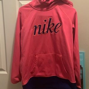 Large pink Nike hoodie.